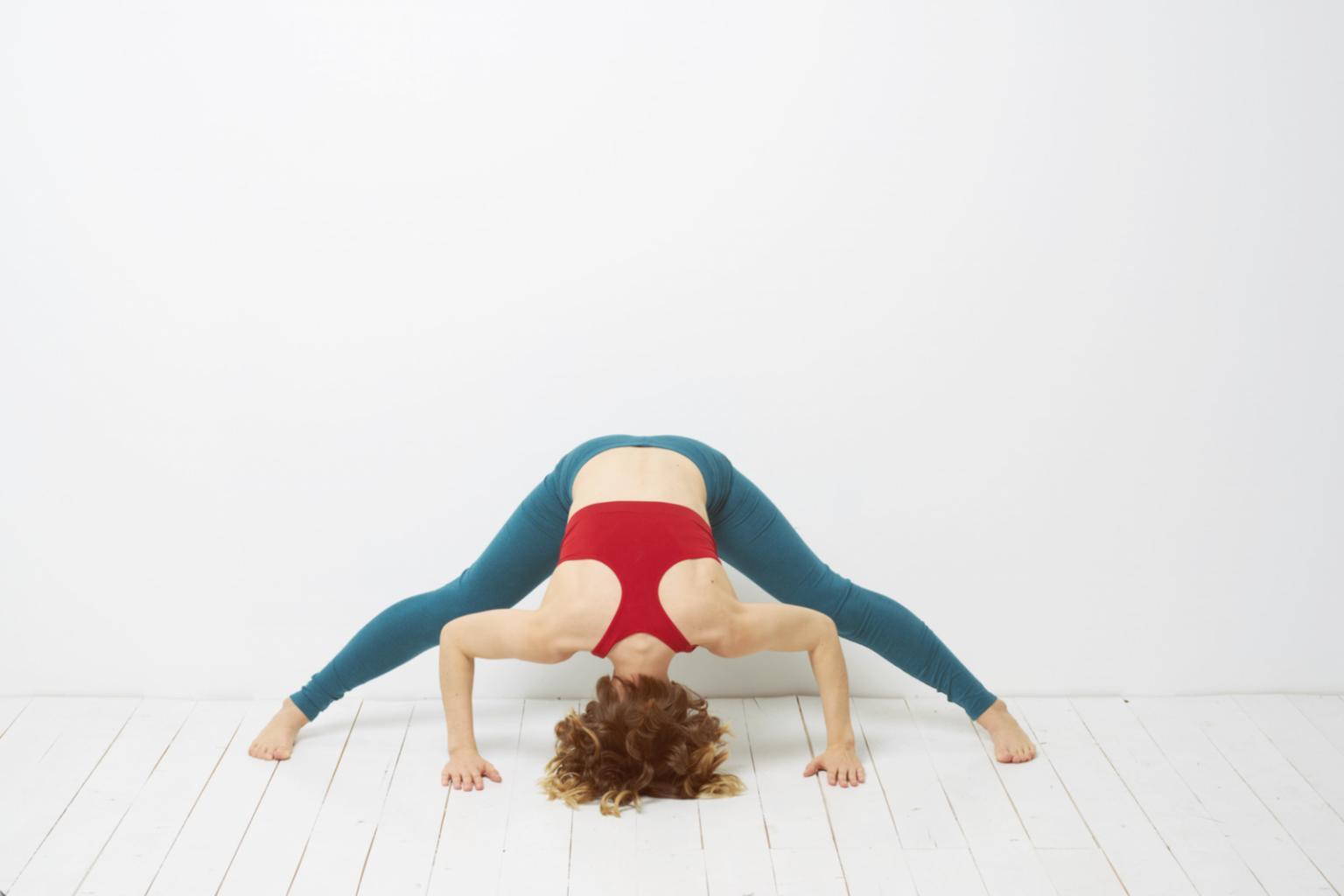 Athlete performing yoga stretches in training facility
